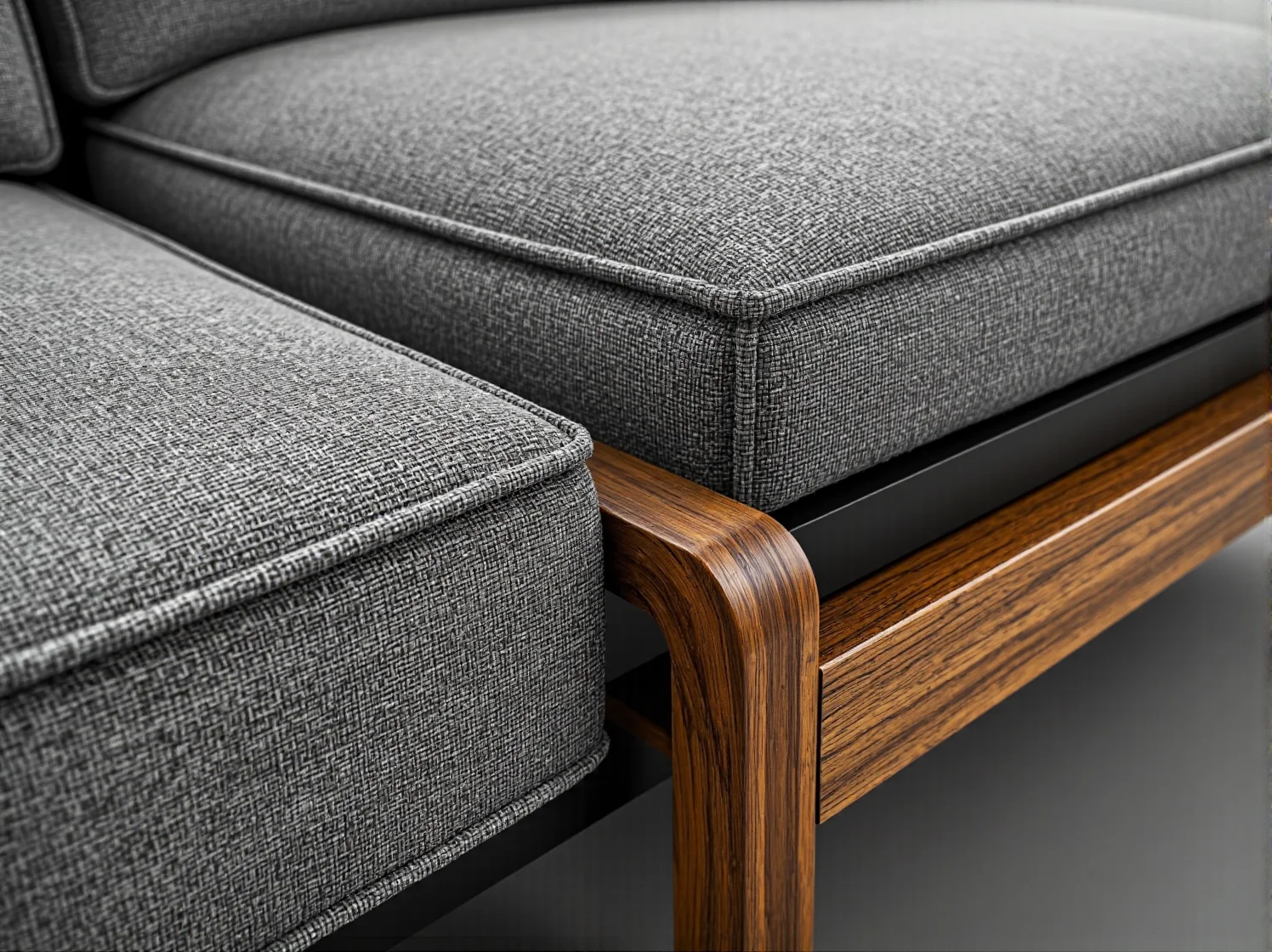 Szara sofa tapicerowana na drewnianej ramie z orzecha